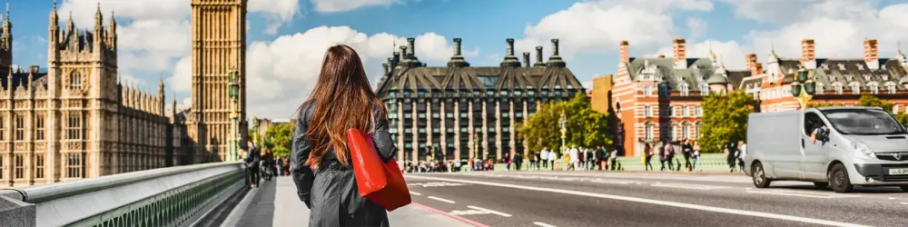 Woma walking in London near Big Ben